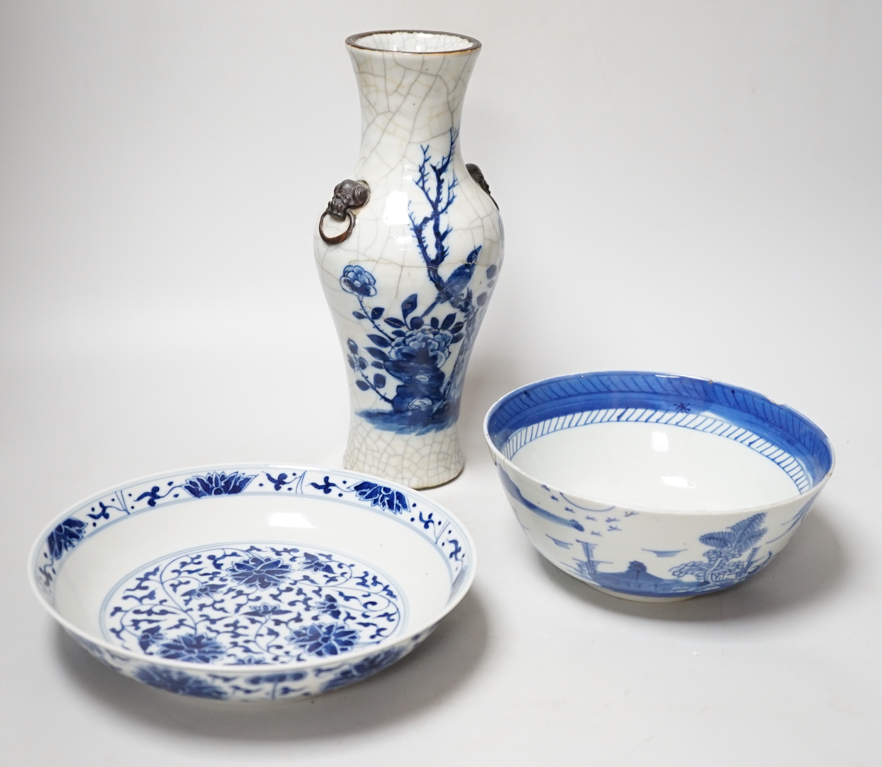 A Chinese blue and white bottle vase with figural decoration and two similar bowls, vase 17cm tall